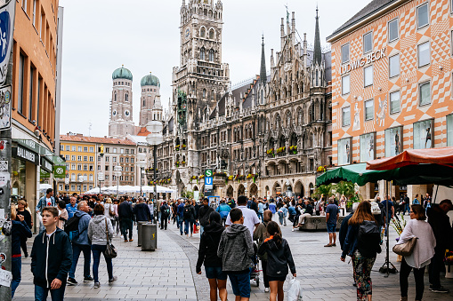 Crowd of people on Marienplatz in Munich. Munich's Marienplatz is the city's most famous square. Located in the heart of the Old Town. The New Town Hall (Neues Rathaus) on the background.