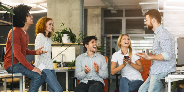 istock Group of colleagues laughing together during coffee break 1189346414