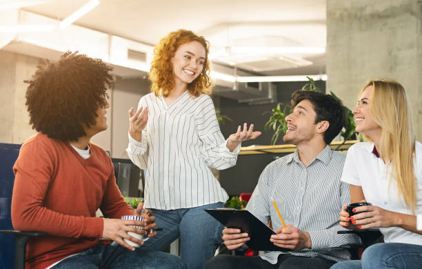 istock Creative woman explaining her business vision to colleagues 1189347611