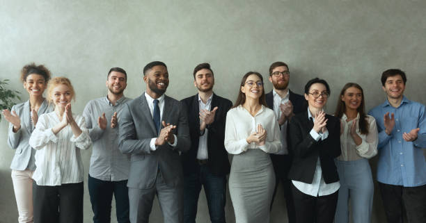 istock Group of business people clapping hands to congratulate boss 1189347661