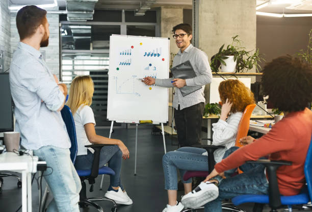 istock Young coworkers discussing investment statistics in office 1189347748