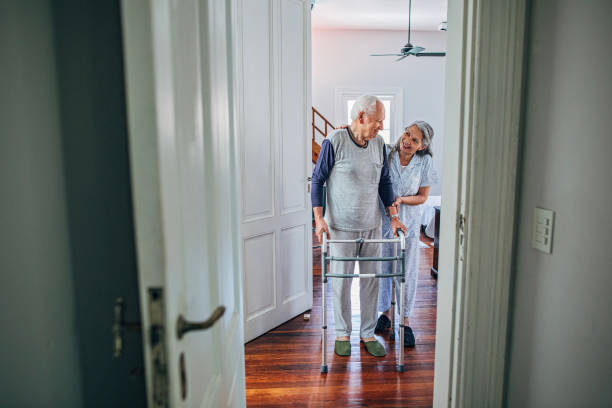 istock Senior wife helping her husband with mobility walker 1189349171