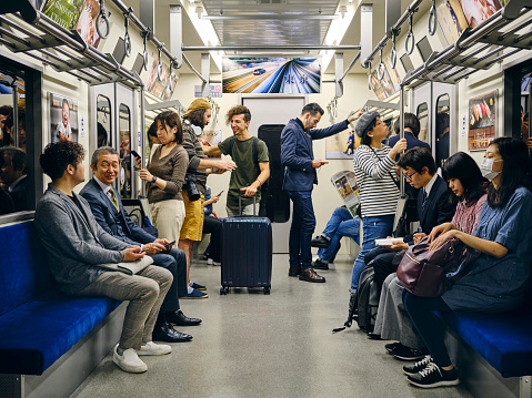 A crowd of people on a Japanese subway train. Fully property released location.