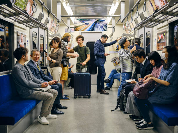 Crowded Japanese Subway Train A crowd of people on a Japanese subway train. Fully property released location. subway platform stock pictures, royalty-free photos & images