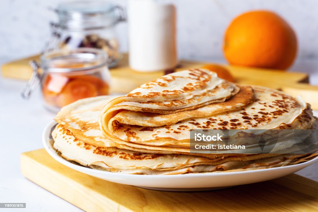 Thin pancakes on white rustic table Thin pancakes on white rustic table, ingredients, making blini, domestic kitchen and crepes Crêpe - Pancake Stock Photo