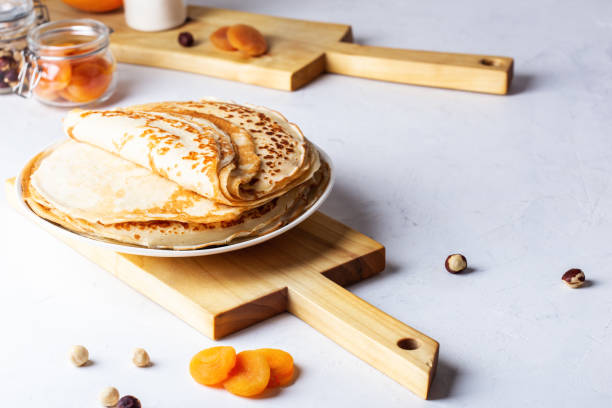 Thin pancakes on white rustic table Thin pancakes on white rustic table, ingredients, making blini, domestic kitchen and crepes crêpe pancake photos stock pictures, royalty-free photos & images