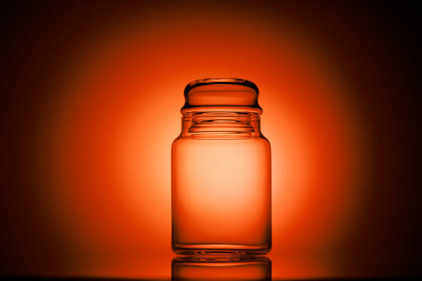 Empty glass jar on a red and black background