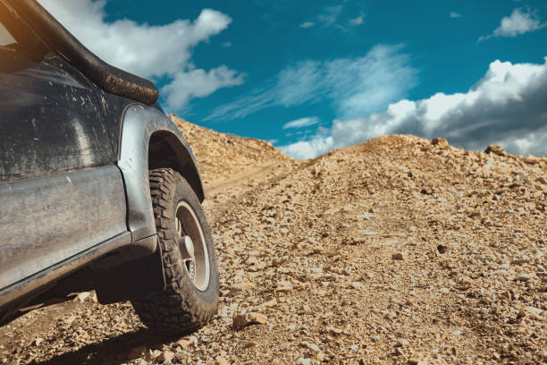 istock 4x4 off road ready car goes uphill 1189358884