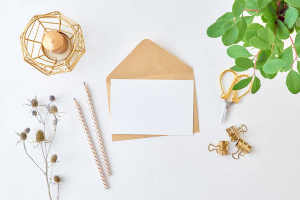 istock Mockup white greeting card and envelope with branches with green leaves on a light background 1189360822