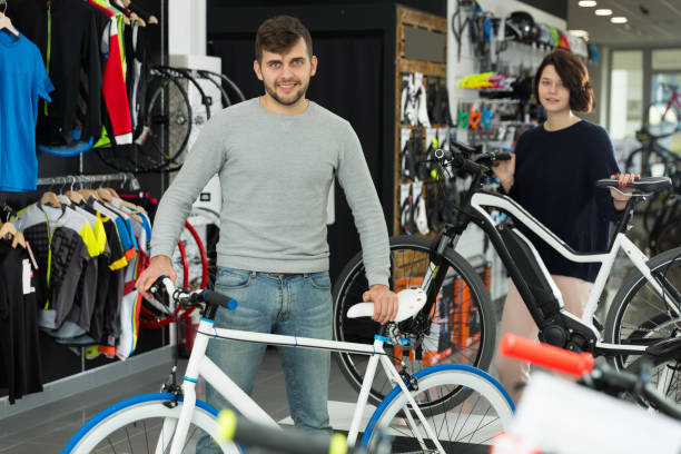 istock adult smiling pair standing with bicycle 1189363008