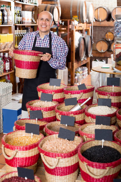 istock Seller taking dried beans with scoop from basket 1189363101