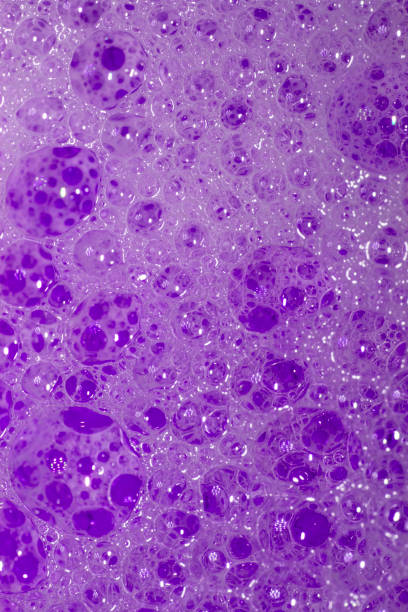 Close Up of Bath Water Bubbles Foam For Background In Purple stock photo