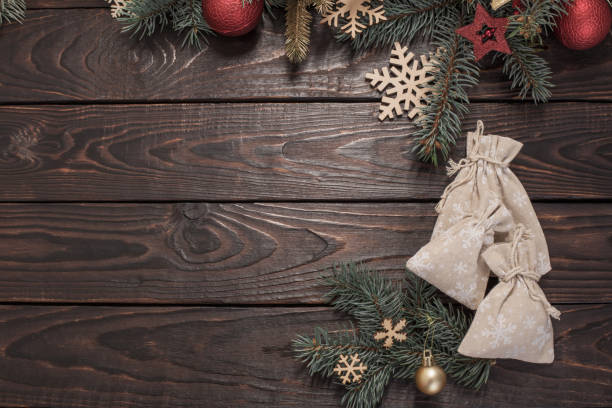 istock fir branches with Christmas decor on old dark wooden background 1189364956