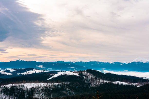 istock Winter tranquil stretched mountain landscape and the Carpathian mountain range behind. 1189365317
