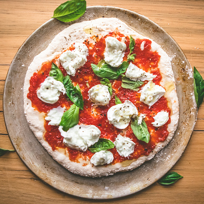 Classic italian pizza uncooked, ready for the oven.