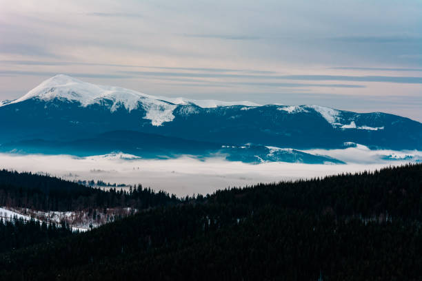 istock Winter tranquil stretched mountain landscape and the Carpathian mountain range behind. 1189365422