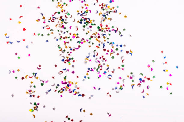 istock scattered colored sequins of various shapes on a white background 1189366956
