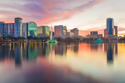 Orlando, Florida, USA downtown city skyline from Eola Park at dusk.
