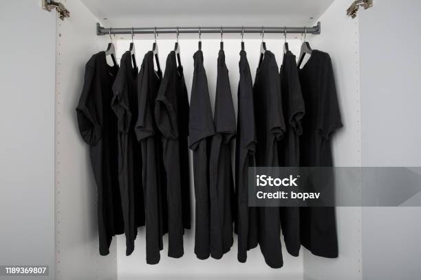 Black Shirts On Hangers In A Row Stock Photo - Download Image Now - Black Color, Clothing, Closet