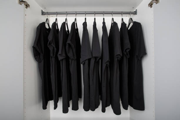 black shirts on hangers in a row - dull colors imagens e fotografias de stock