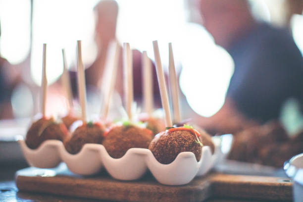 Arancini, rice balls served in the style of cake pops.