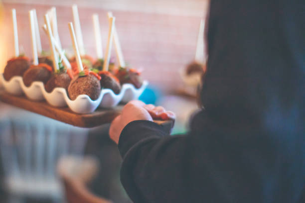 Arancini, rice balls served in the style of cake pops.