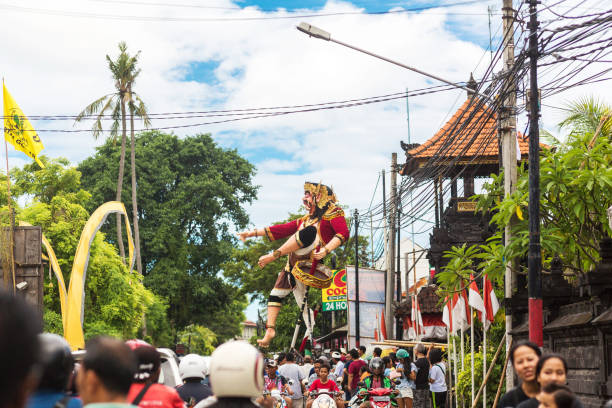 parade on the street of bali island. people carry a huge statue of a four-armed demon. - bali sculpture balinese culture human face imagens e fotografias de stock