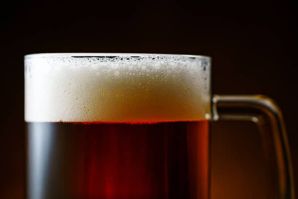 istock Dark Beer Mug with Foam Close Up 1189371142