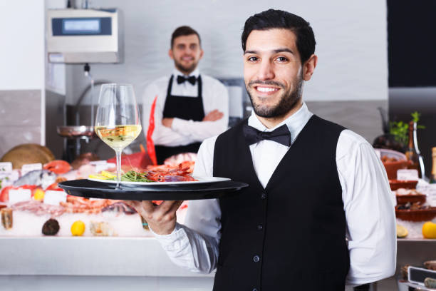istock Waiter standing in fish restaurant 1189371391