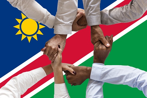Flag of Namibia , intergration of a multicultural group of young people.