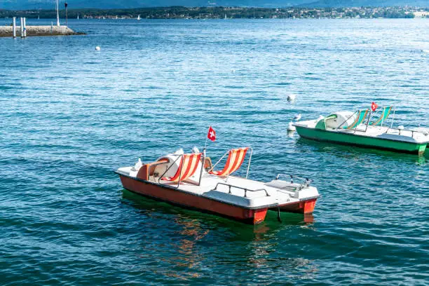 Lake Geneva, Switzerland.  With pedallos for hire moored in the bay at Prangins.