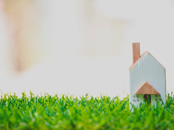 istock Closeup miniature house on wooden table with copy space concept. 1189373405