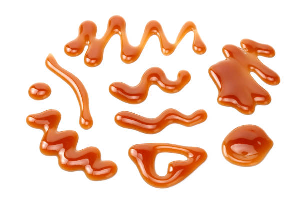 istock caramel sauce isolated on white background. caramel wave 1189374189