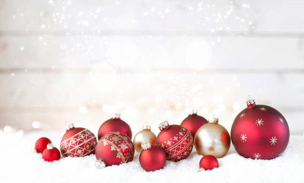 Christmas holiday red baubles against an old wood background Christmas holiday red and gold baubles, festive and sparkling lights against an old wood background medium group of objects stock pictures, royalty-free photos & images