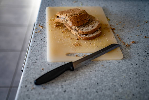 Wholemeal bread freshly cut with crumbs all around the work top