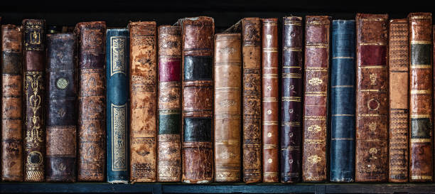 istock Old books on wooden shelf. Tiled Bookshelf background. 1189377694