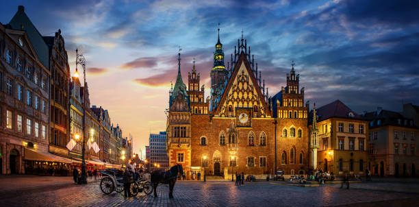 Wroclaw central market square with old houses, Town Hall and sunset, horse and carriage. stock photo