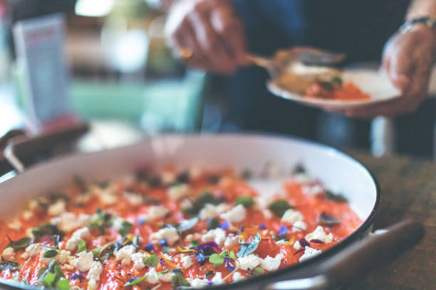 Large plate of sliced gravlax on a rustic wooden table.