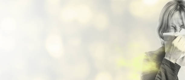 istock sneezing woman with pollen allergy on abstract background 1189380043