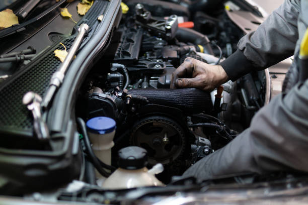 Close up hand of auto mechanic doing car service and maintenance. Services car engine machine.