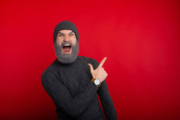 istock Amazed screaming young man with white beard pointing at offer, copyspace 1189380344