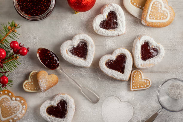 istock Homemade heart shaped  cookies with raspberry jam on white wooden table 1189384249