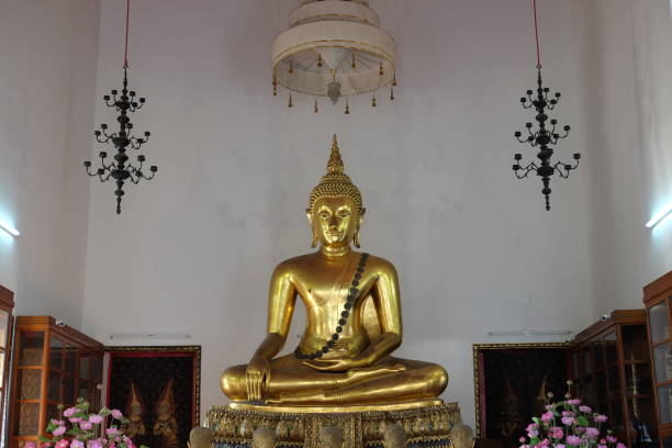 istock Gilded Buddha statue sitting in lotus position. Statue from a Buddhist monastery. 1189385658