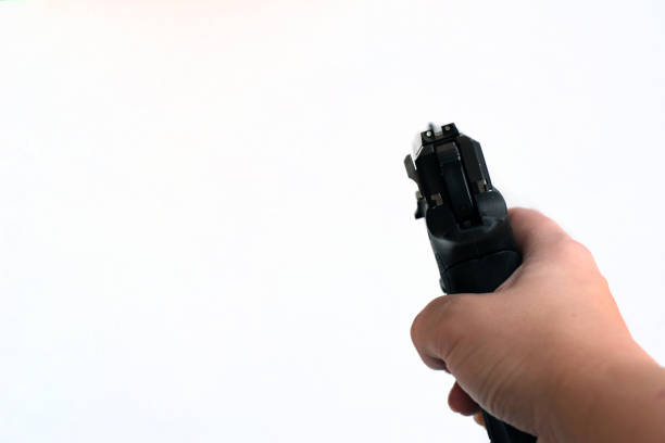 istock Woman pointing a gun at the target on a white background 1189386436