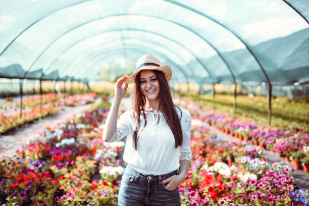 Female Walking Through Her Beautiful Greenhouse
