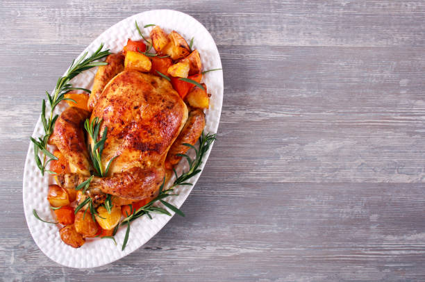 istock Roast whole chicken with vegetables and rosemary 1189390252