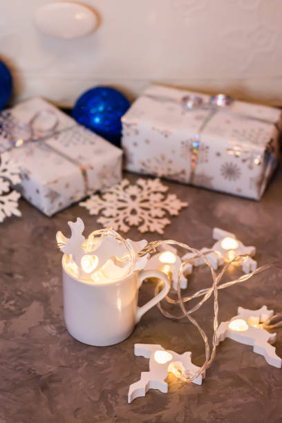 istock Christmas still life. Garland with deers in a white cup 1189395050