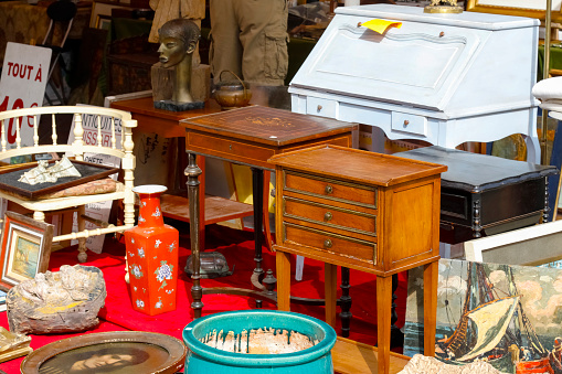 Nice, France - 17 September 2018: Second hand furniture and other interior furnishings are visible at the flea market in Cours Saleya, the famous city market offering antiques and many other products. Cours Saleya Market in Nice is located on the French Riviera in the Provence-Alpes-Cote d'Azur region