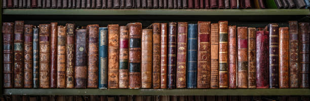 istock Old books on wooden shelf. Tiled Bookshelf background. 1189397262