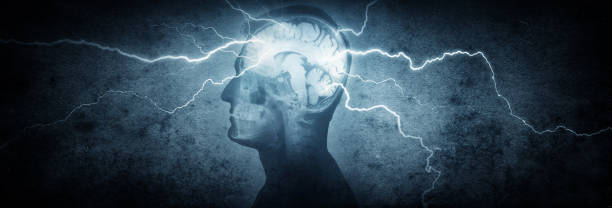 Silhouette of a man's head with x-rayed head and lightning coming out of the brain. stock photo